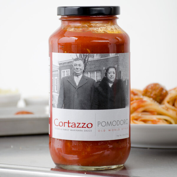A close up of a jar of Cortazzo Pomodoro sauce with red sauce inside.