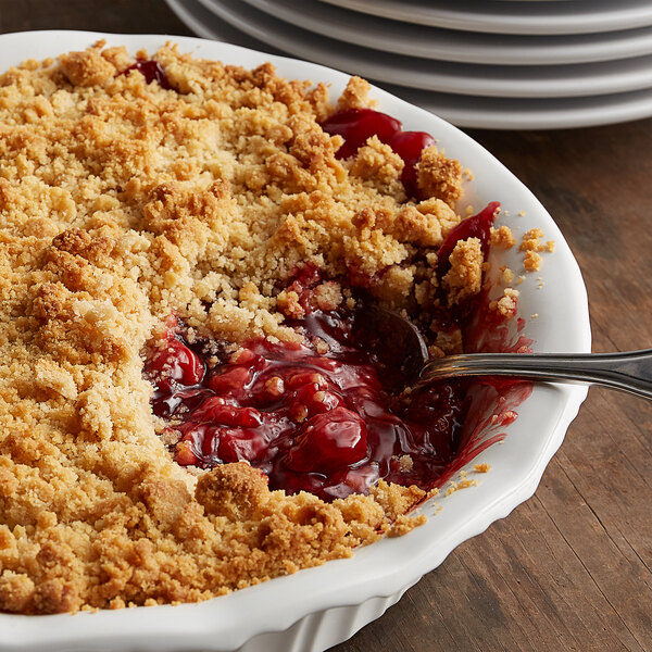 A bowl of Lawrence Foods cherry pie filling with a spoon.