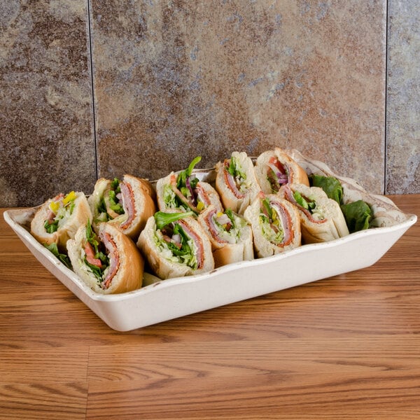 A GET Olympia melamine tray of sandwiches on a table.