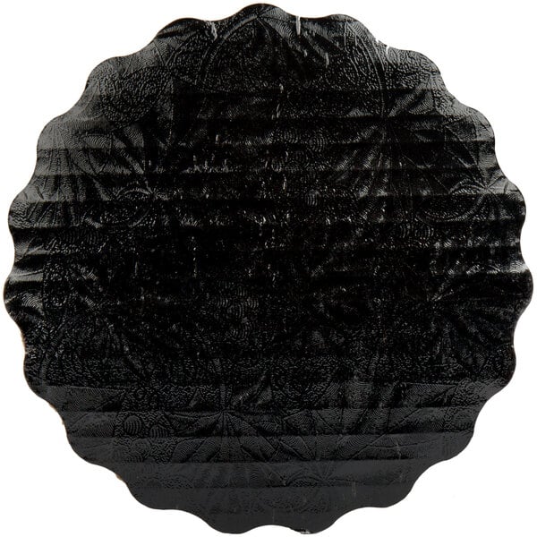 A black Enjay laminated corrugated cake circle with a pattern on it.