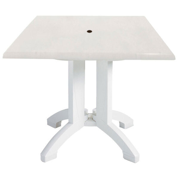 A white square Grosfillex pedestal table with a hole in the middle.