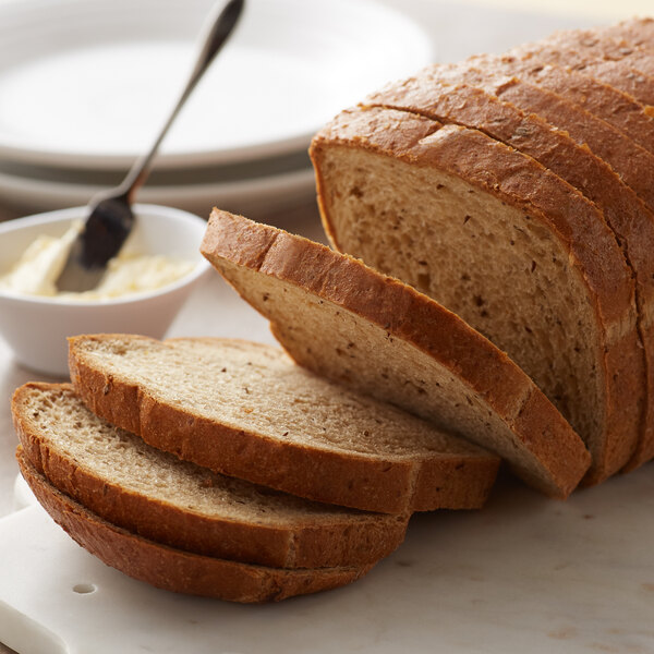 A sliced Bakery de France Rye Bread loaf on a cutting board.