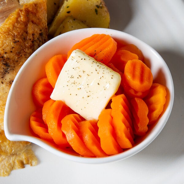 A white bowl of crinkle cut carrots.