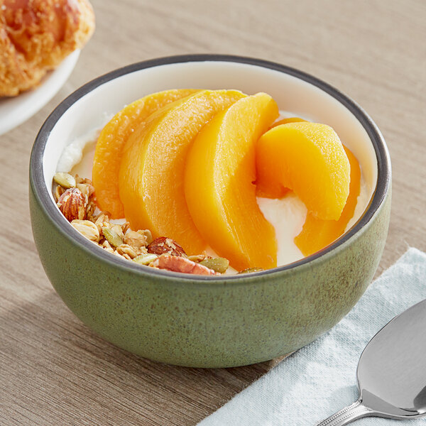 A bowl of yogurt with IQF sliced peaches.