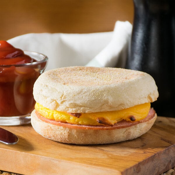 A Jimmy Dean Canadian Bacon, Egg, and Cheese breakfast sandwich on a plate.