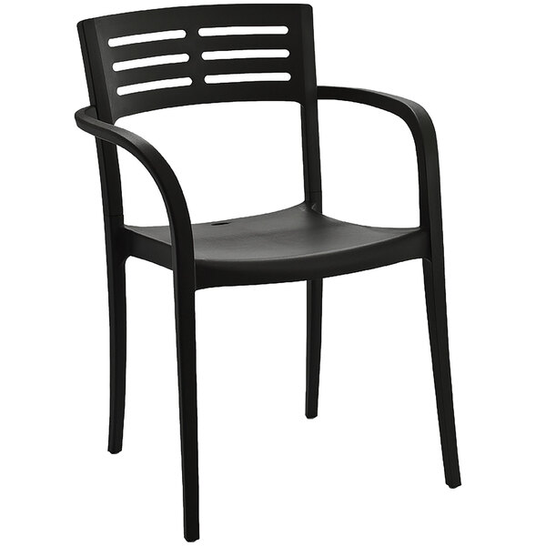 A pack of 4 black Grosfillex Vogue stackable armchairs.