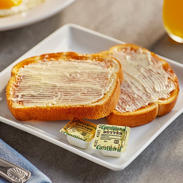 A plate of toast with Grassland butter and a glass of juice.