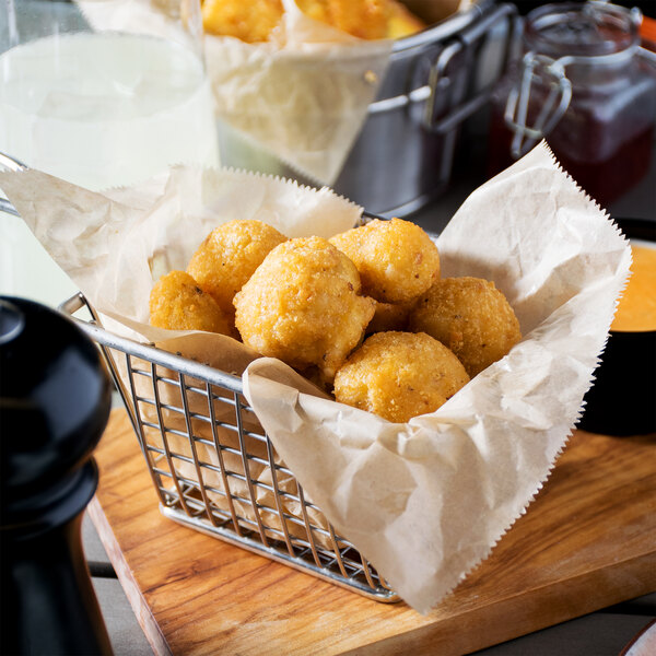 A basket of McCain Anchor Battered Mushrooms on a table.