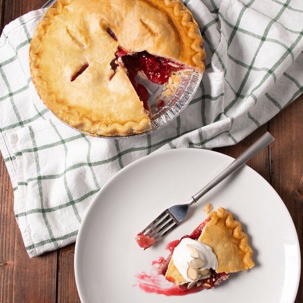 A slice of Red Tart Cherry pie on a plate with a fork.