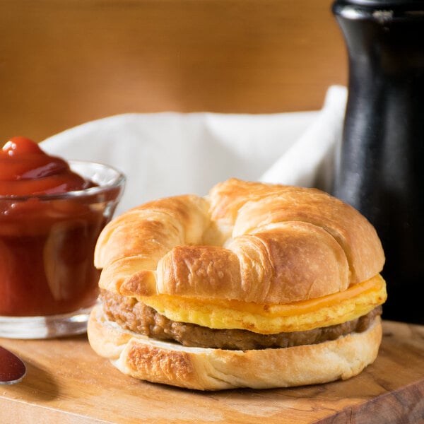 A Jimmy Dean breakfast sandwich with sausage, egg, and cheese on a plate.