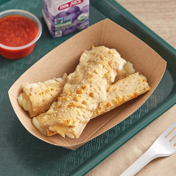 A brown tray of MaxStix whole grain pizza sticks with a white plastic fork.