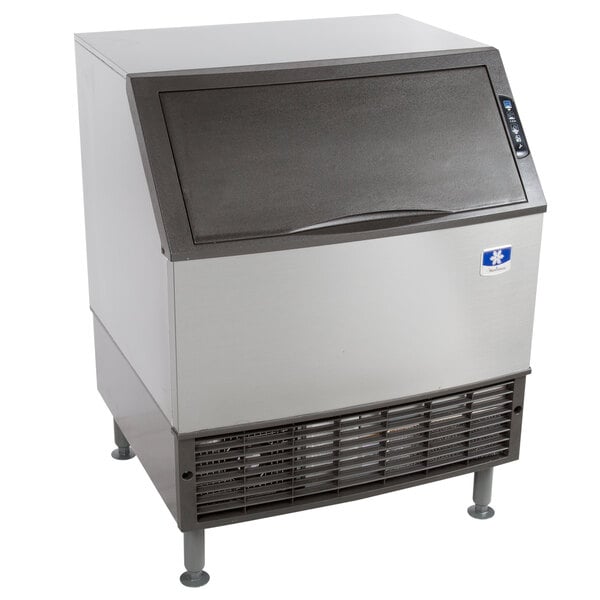 A large silver and black Manitowoc undercounter ice machine.