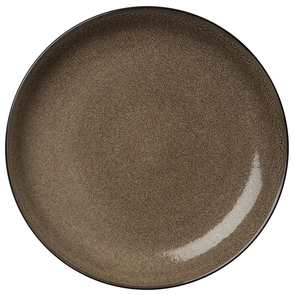 A close up of a Oneida Rustic Chestnut porcelain coupe plate with a brown surface.