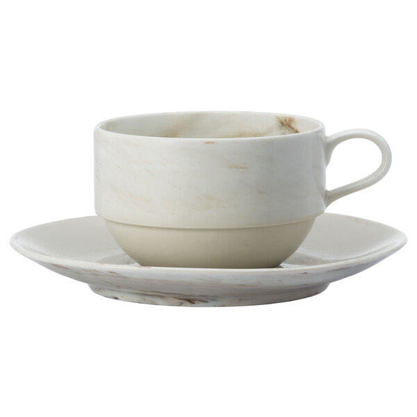 A white Oneida porcelain saucer with a white cup and saucer on it.