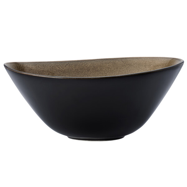 A white porcelain soup bowl with a black and brown rim.