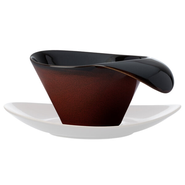 A brown and black Oneida Rustic teacup with a white saucer.
