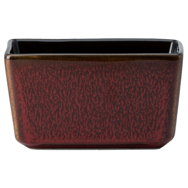 A rectangular red and black Oneida Rustic porcelain sugar caddy.