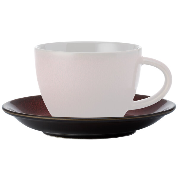 A white Oneida Rustic tea cup and saucer on a white saucer.