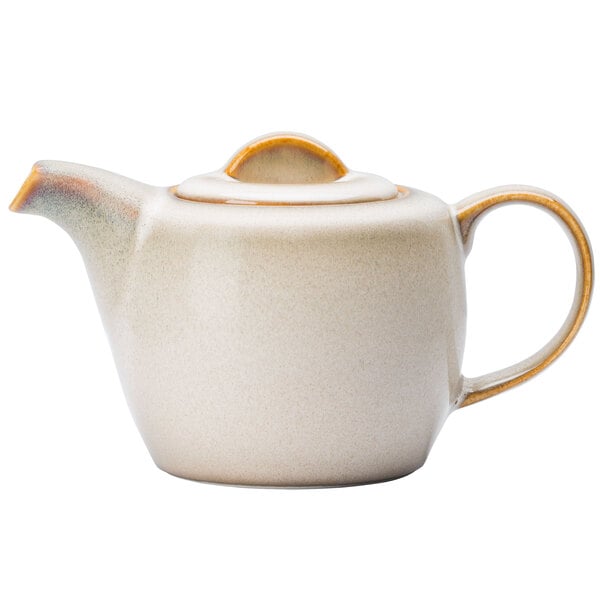 A white porcelain teapot with a yellow rim and brown handle.