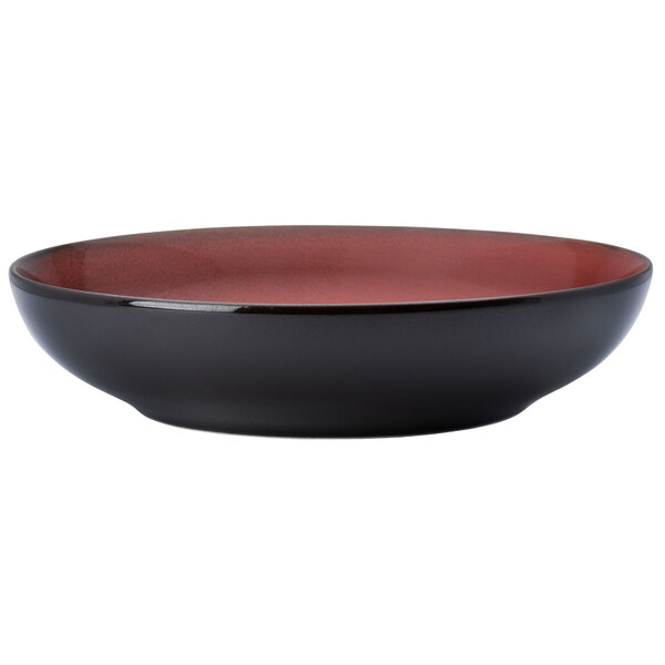 A white porcelain bowl with a black and red design.