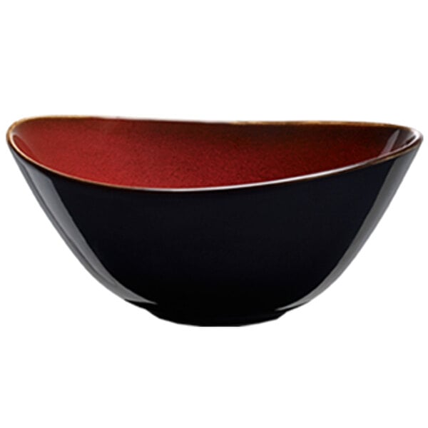 A close-up of a crimson and white Oneida Rustic porcelain soup bowl with a black and red surface.