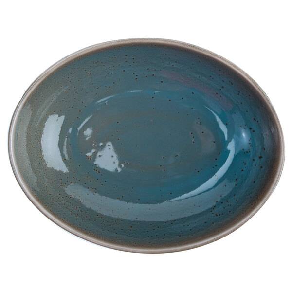 A white Oneida Terra Verde Dusk oval bowl with a blue and brown speckled design.