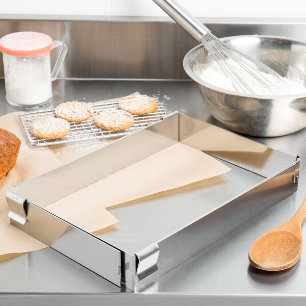 A Matfer Bourgeat stainless steel sheet pan extender on a baking sheet with cookies.