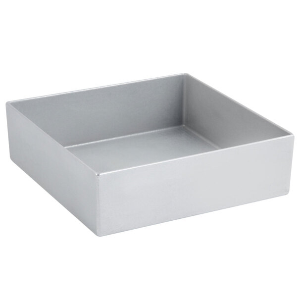 A silver square Bon Chef bowl with a lid on a white surface.