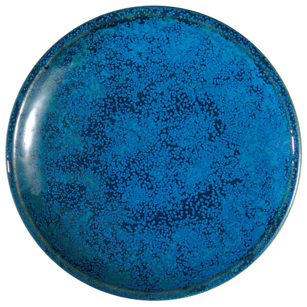 A Oneida Studio Pottery Blue Moss porcelain plate with a blue speckled surface.