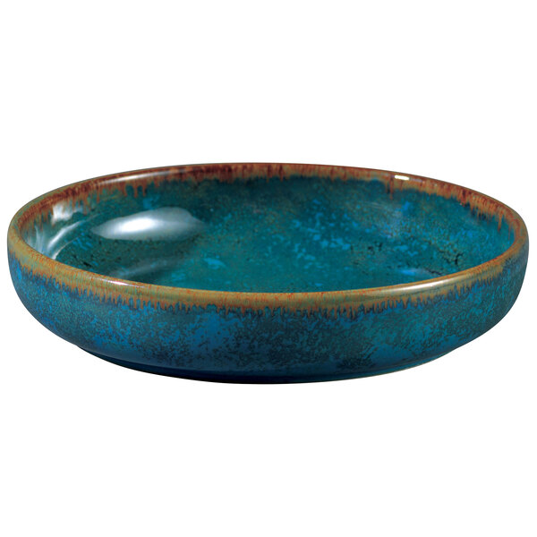 A close-up of a blue Oneida Studio Pottery bowl with a brown rim.