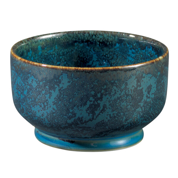 A blue Oneida Studio Pottery ramekin with brown specks.