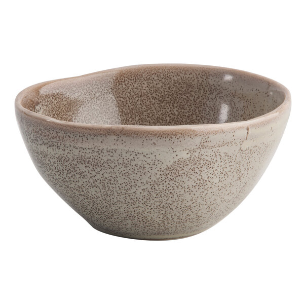 A white porcelain sauce bowl with speckled brown design.