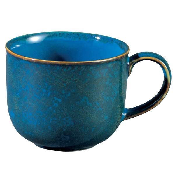 A white porcelain mug with a blue moss design and gold rim.