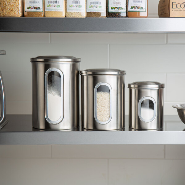 A Fox Run stainless steel ingredient canister set on a kitchen counter.