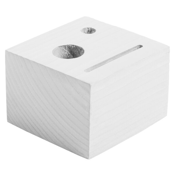 A customizable white wash wood block check presenter with a face and a line carved into it.