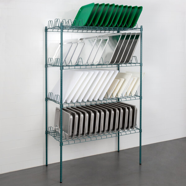 A Regency green wire rack with shelves holding trays.