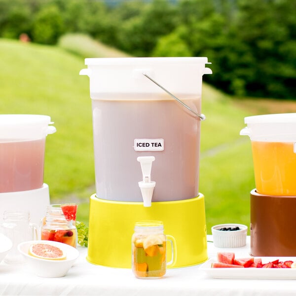 A white Choice plastic beverage dispenser with a yellow base full of yellow liquid.