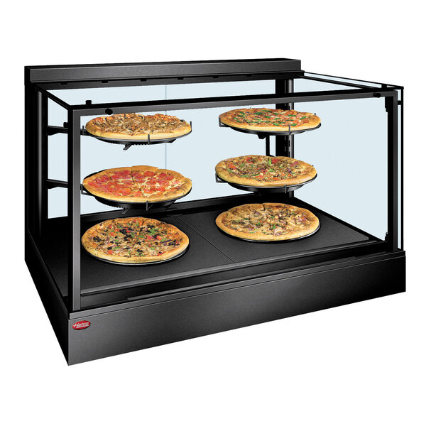 A Hatco countertop display warmer with pizzas on it.