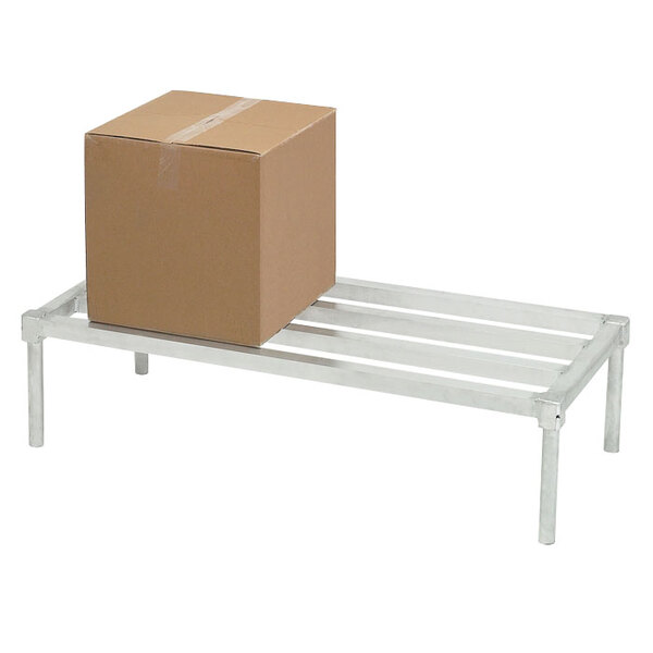 A cardboard box sits on a Channel heavy-duty aluminum dunnage rack.