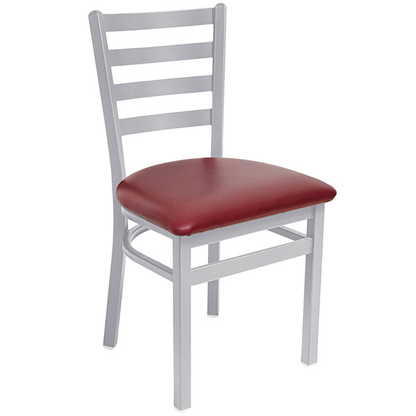 A BFM Seating silver metal side chair with a burgundy vinyl seat.