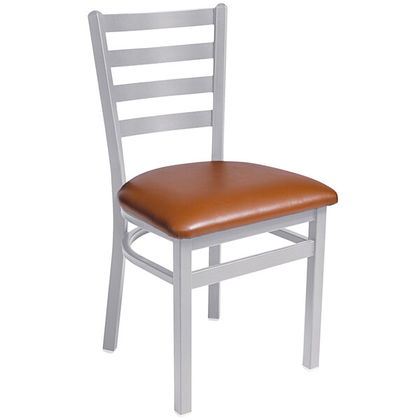 A BFM Seating Lima metal side chair with a light brown vinyl seat.