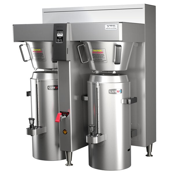 A Fetco stainless steel double automatic coffee brewer with two large silver containers.