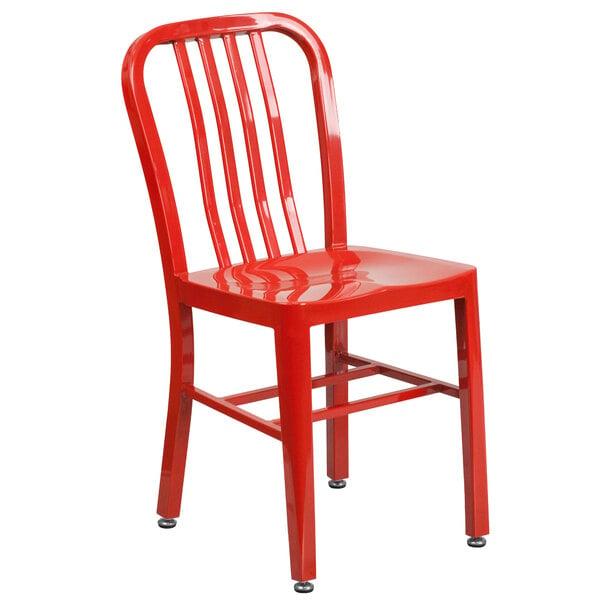 A red metal chair with a vertical slat back on a white background.