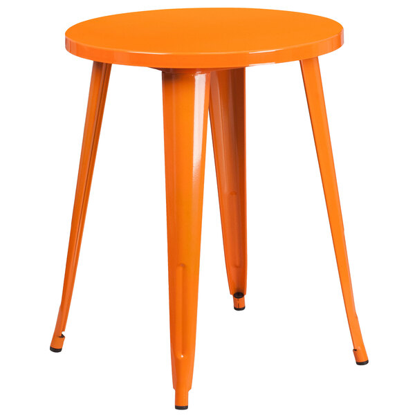 An orange metal round table with legs.
