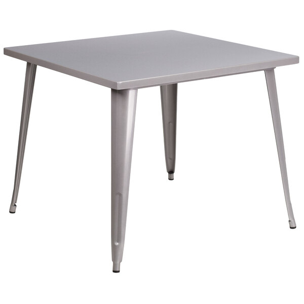 A Flash Furniture silver metal square table with legs.
