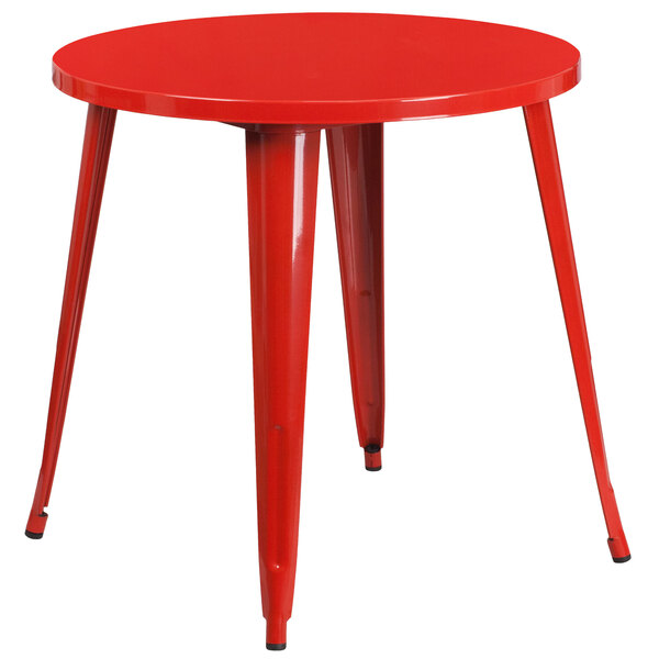 A Flash Furniture red metal round cafe table with legs.