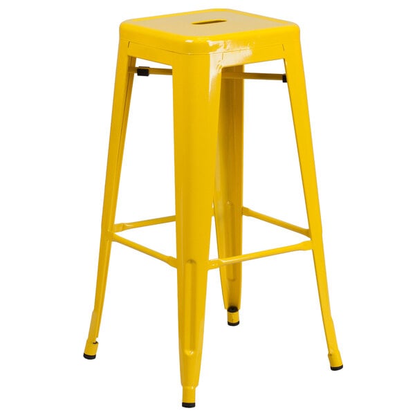 A yellow Flash Furniture metal bar stool with a square seat.