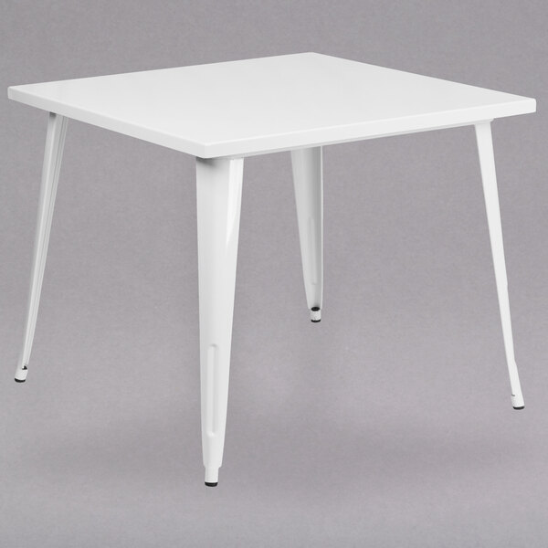 A Flash Furniture white metal square cafe table with legs.