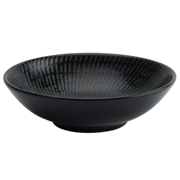 A close up of a black Oneida Urban porcelain bowl with a pattern.