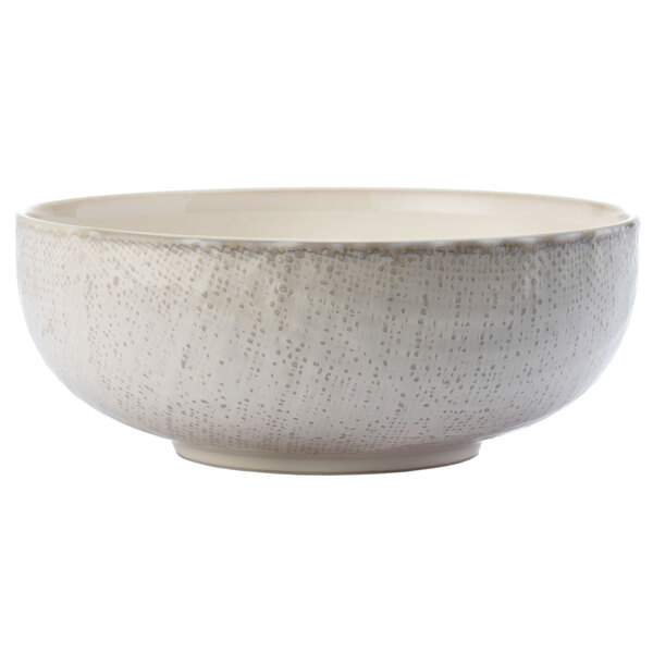 A close-up of a white Oneida Knit porcelain bowl with speckled texture.